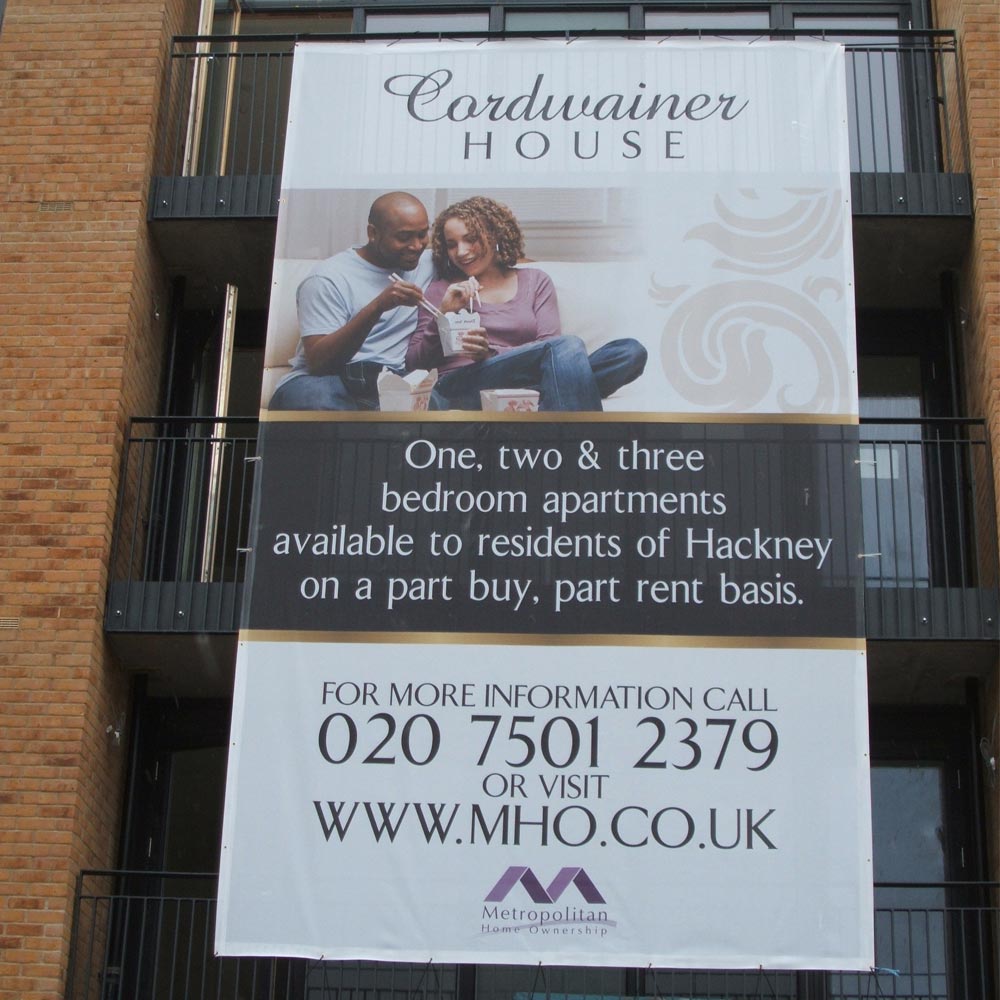 Mesh banner installed on residential properties advertising homes for sale and rent