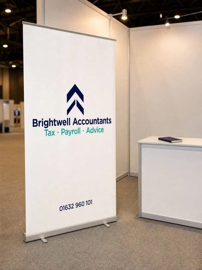 Budget roller banner for Brightwell Accountants beside a counter on an exhibition stand