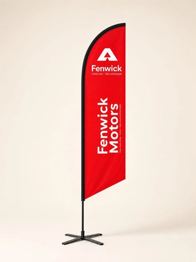 Red custom printed blade flag for Fenwick Motors on a cross base against a plain studio backdrop