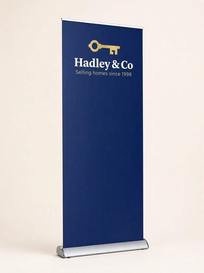Navy interchangeable graphics roller banner for Hadley & Co estate agents on a studio backdrop