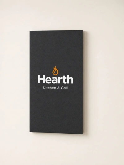 Charcoal SEG wall-mounted fabric display for Hearth Kitchen & Grill hung on a plain cream wall