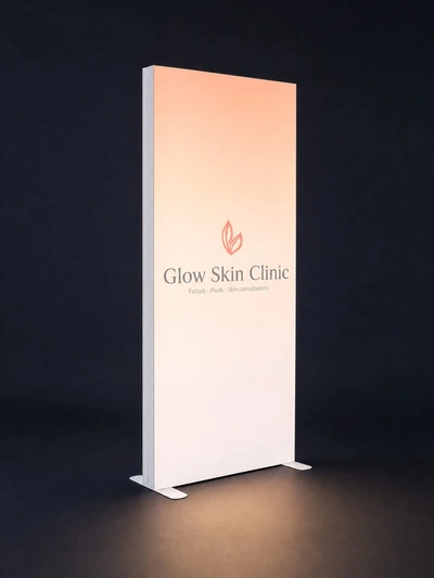 Illuminated SEG free-standing fabric lightbox for Glow Skin Clinic glowing against a dark backdrop