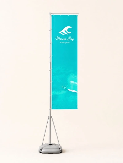Turquoise wind dancer flag for Marina Bay Watersports on a weighted base against a plain backdrop