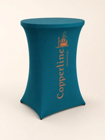 Teal stretch fabric poseur table cover for Copperline small batch gin against a plain backdrop