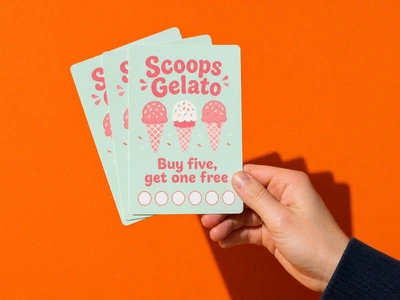 Rounded corner A6 flyers for Scoops Gelato fanned in one hand