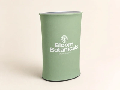 Sage green stretch fabric oval counter for Bloom Botanicals standing against a plain backdrop