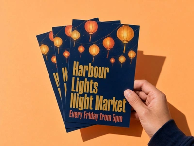 A5 flyers for Harbour Lights Night Market fanned in one hand